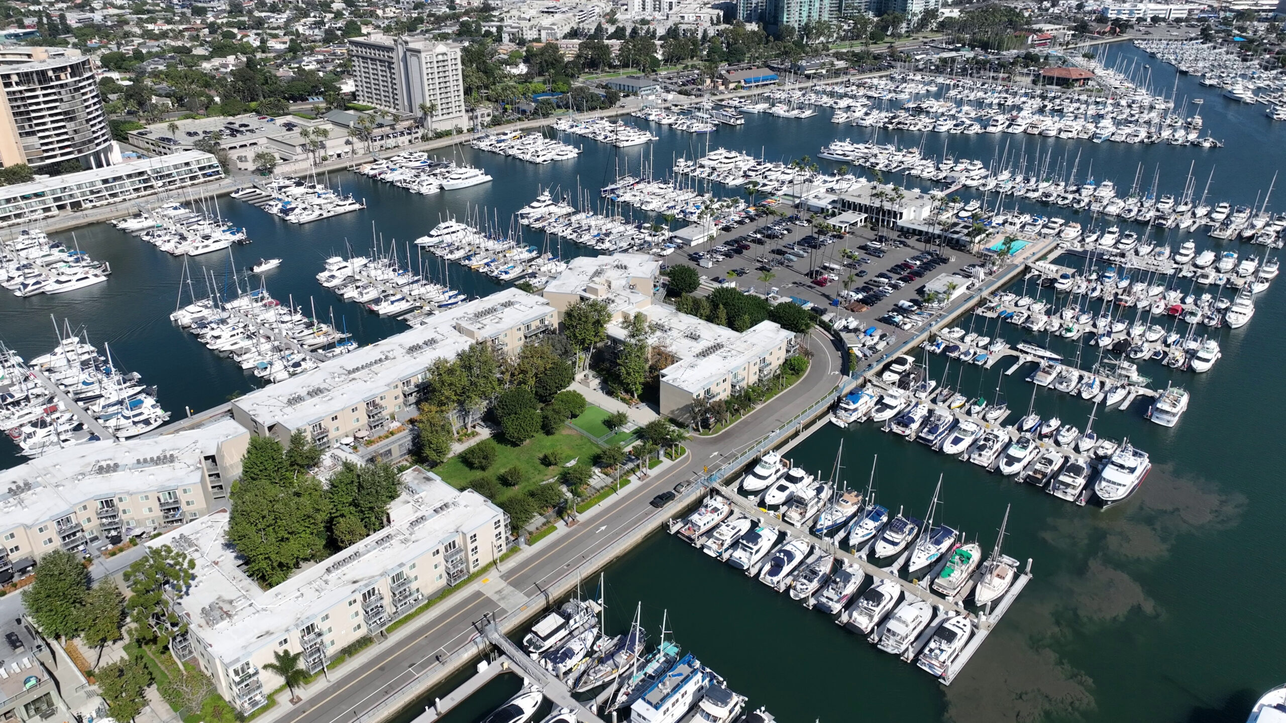 Aerial view of Marina Del Rey harbor in Los Angeles, filled with numerous boats and surrounding city landscape.