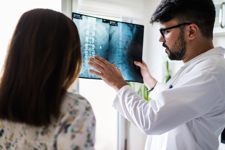 Doctor showing spine test to patient